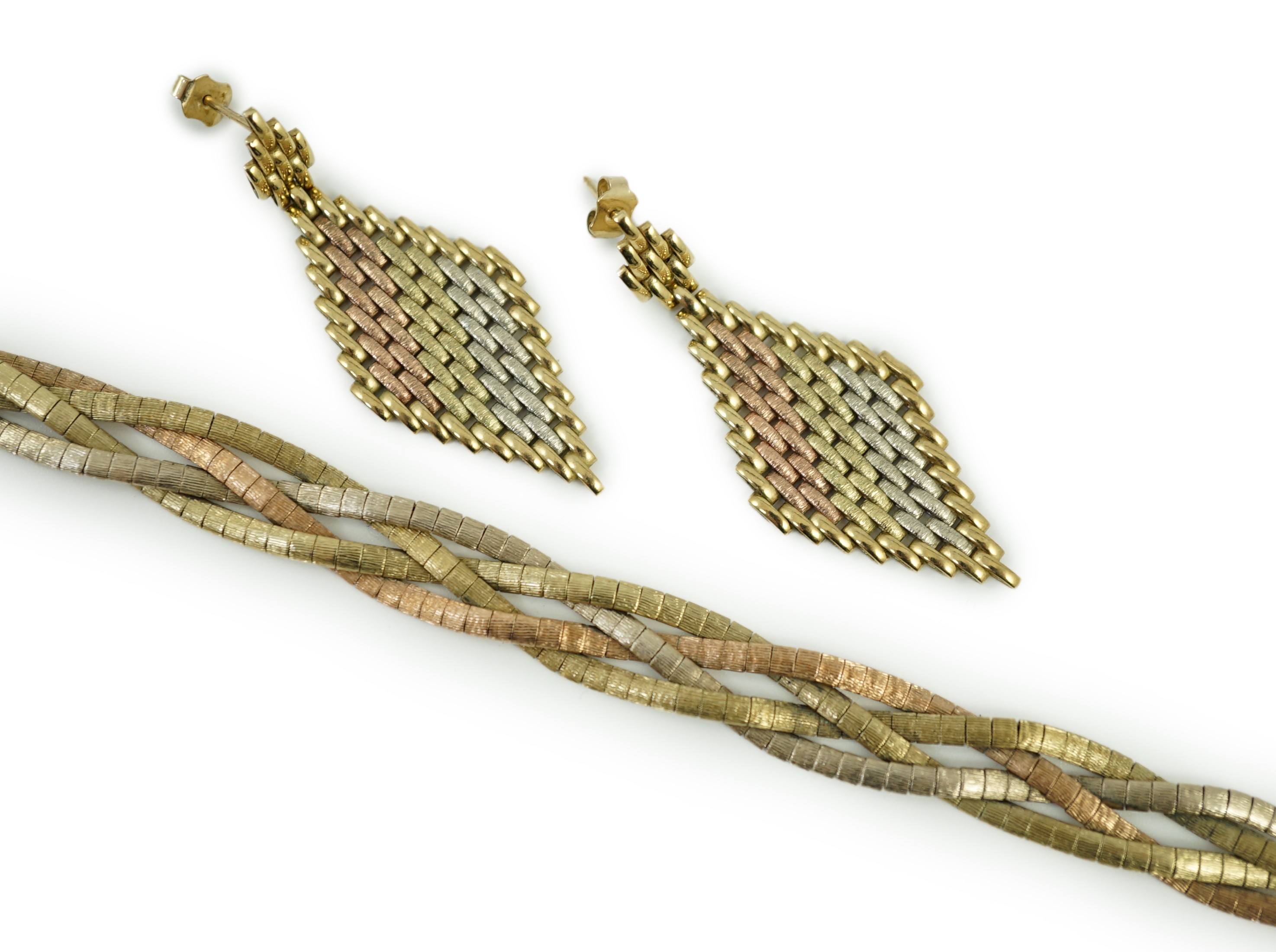 A modern three colour 9ct gold interwoven bracelet, 18.5cm and a pair of similar 9kt drop earrings, 30.6 grams.